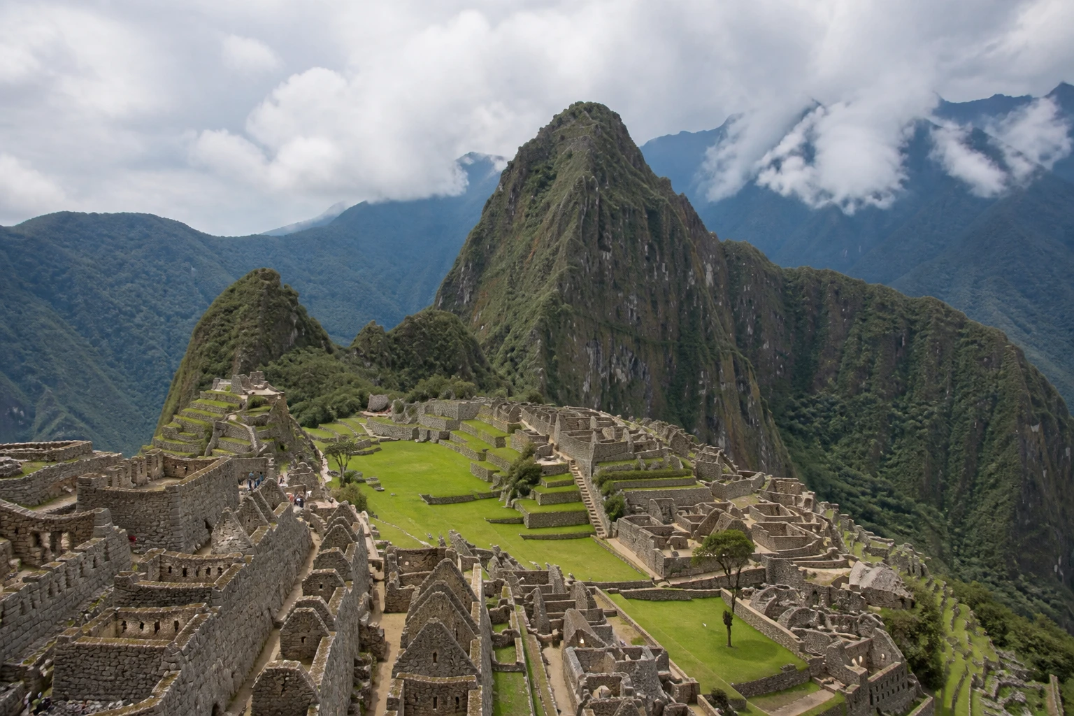Machu Picchu terraces surrounded by green mountains
