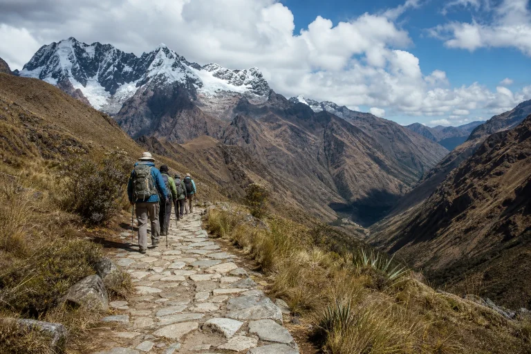 Hikers on a stone trail in the Andean landscape near Cusco