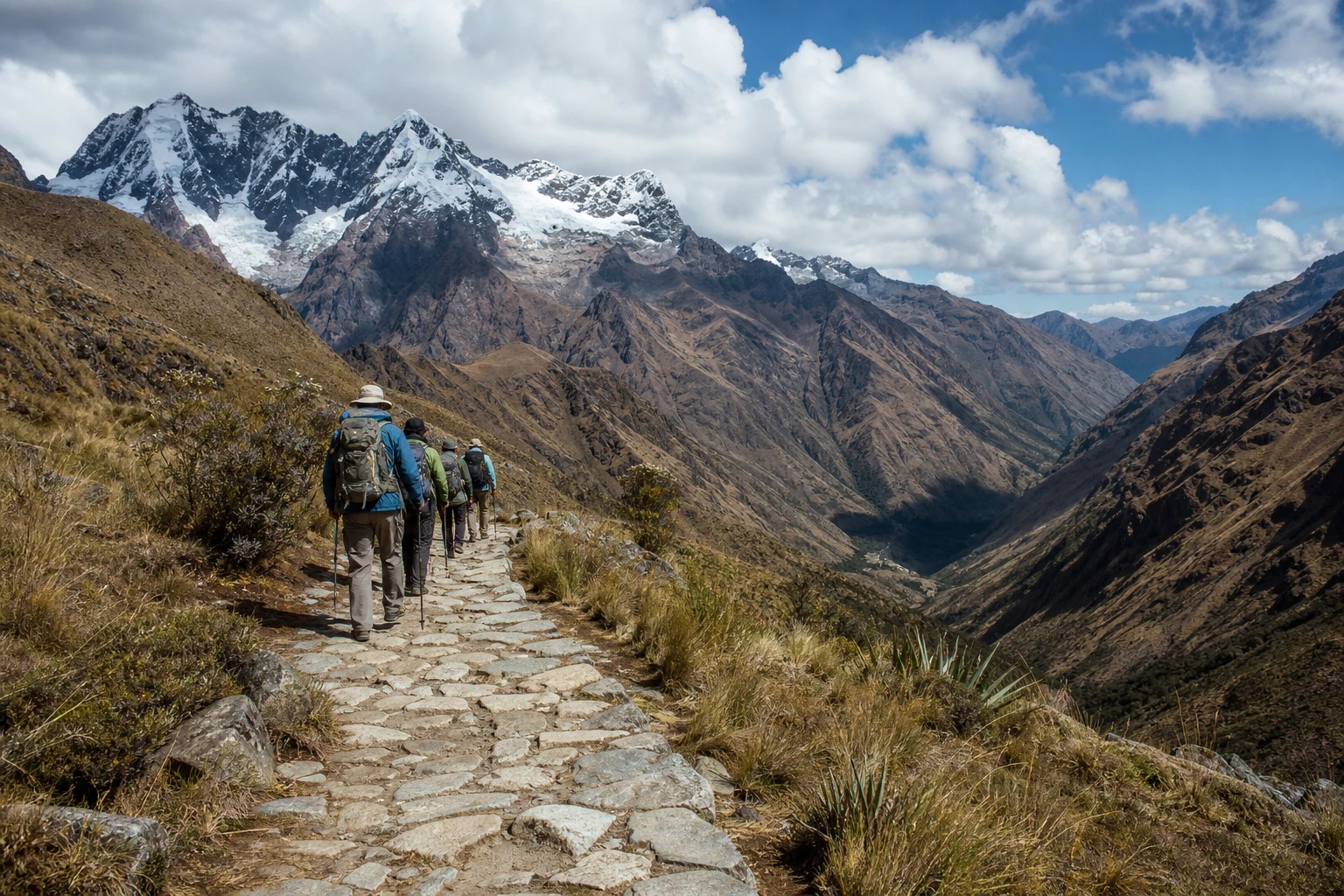 Hikers on a stone trail in the Andean landscape near Cusco