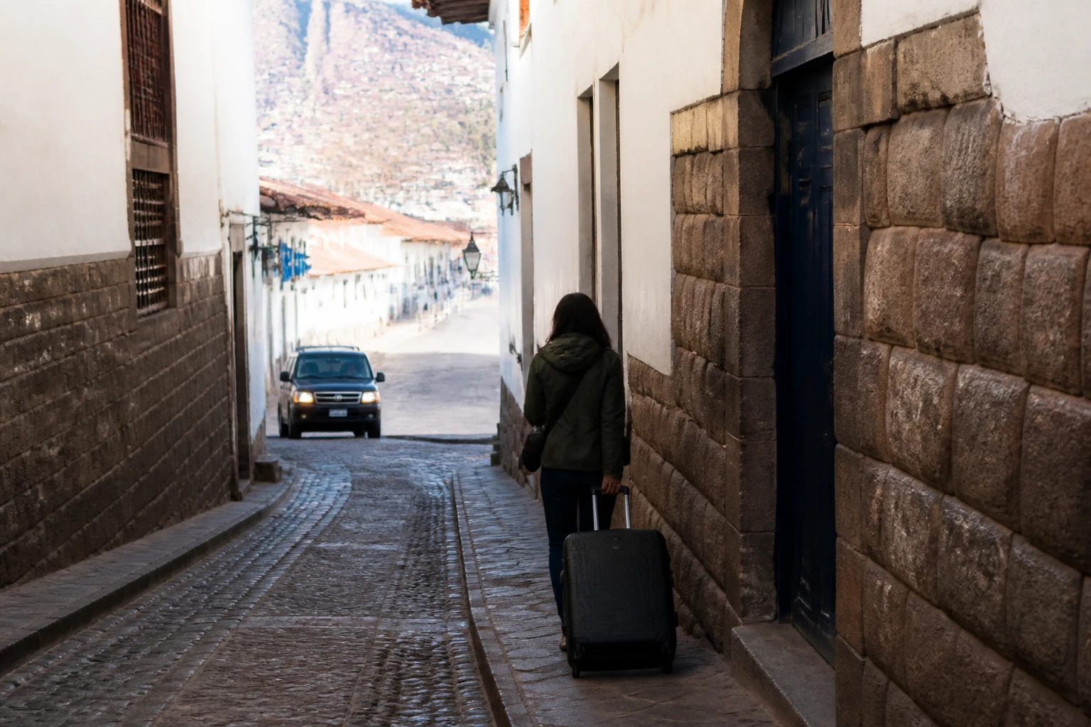 Traveler walking with luggage on a narrow Historic Center street