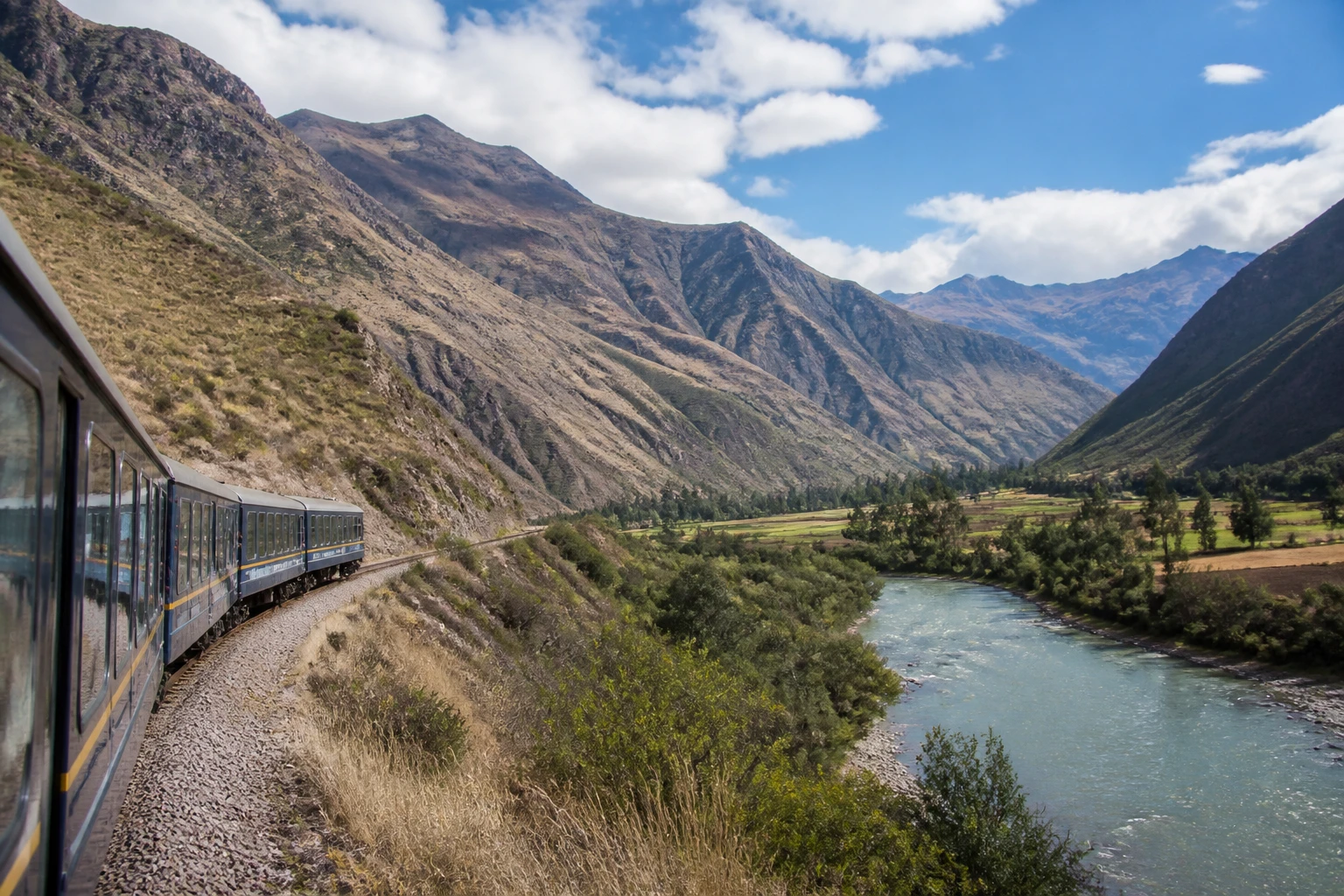 Train traveling through the Sacred Valley near Ollantaytambo
