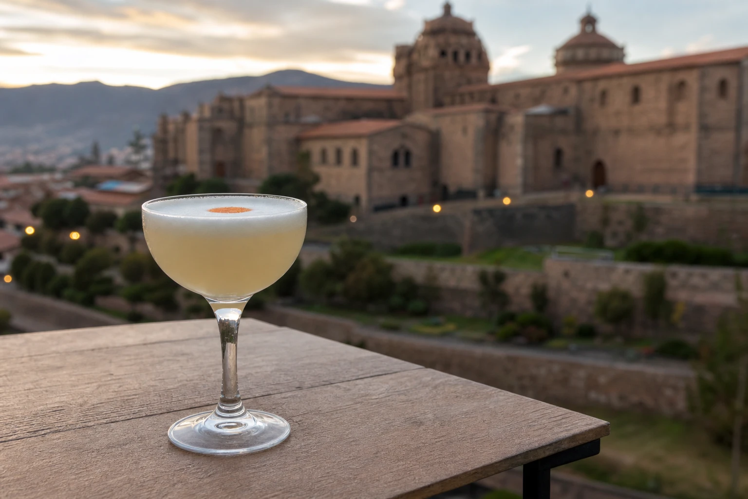 A pisco sour in a stemmed glass during an evening in Cusco
