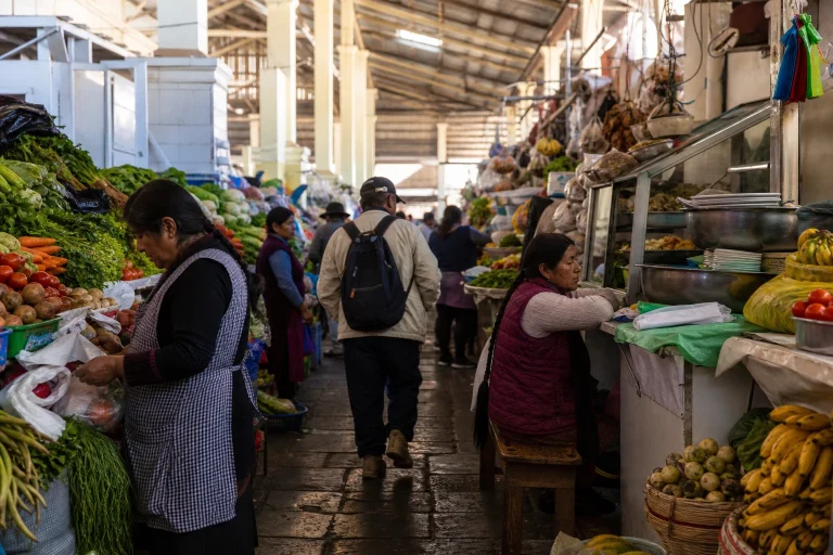 Food counters inside a covered Cusco market