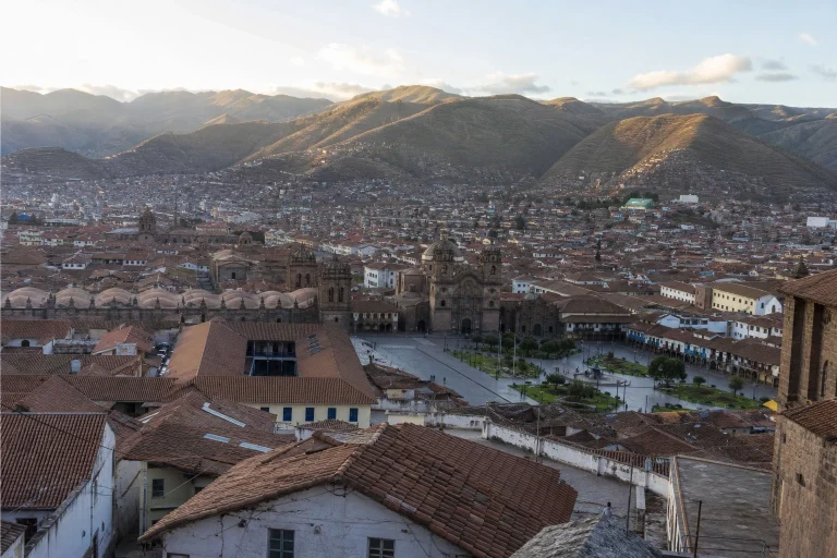 Morning view across Cusco rooftops and mountain-backed streets