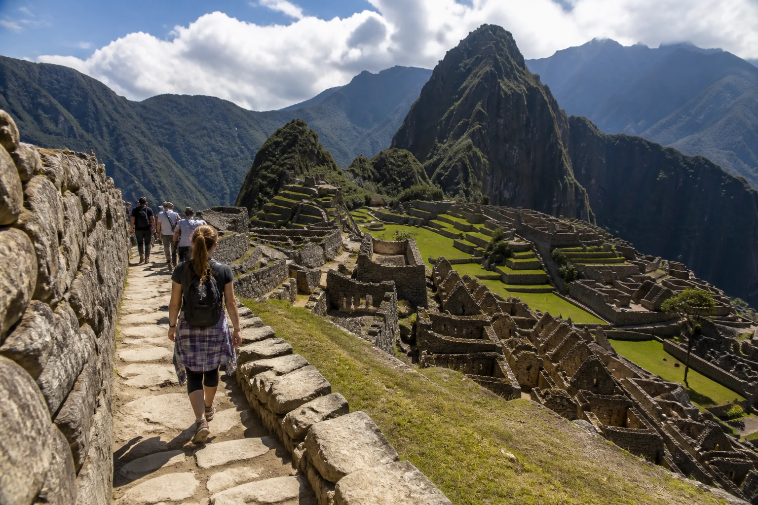 Travelers following a stone route through Machu Picchu