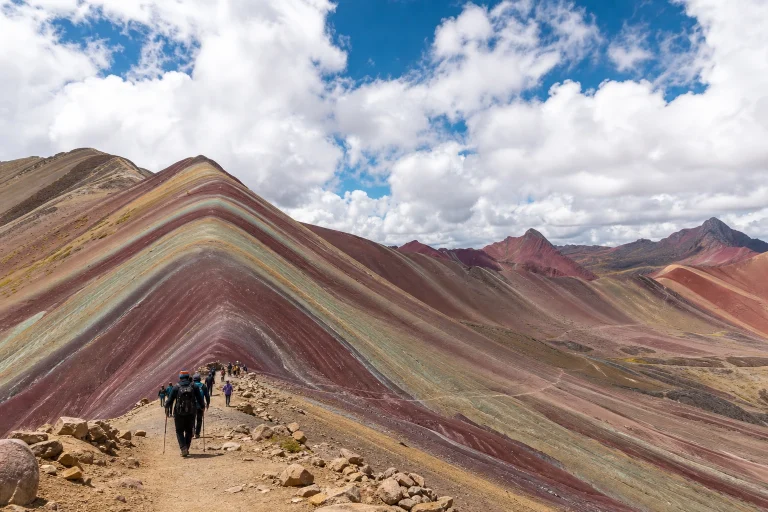 Hikers approaching Rainbow Mountain on a high-altitude trail near Cusco