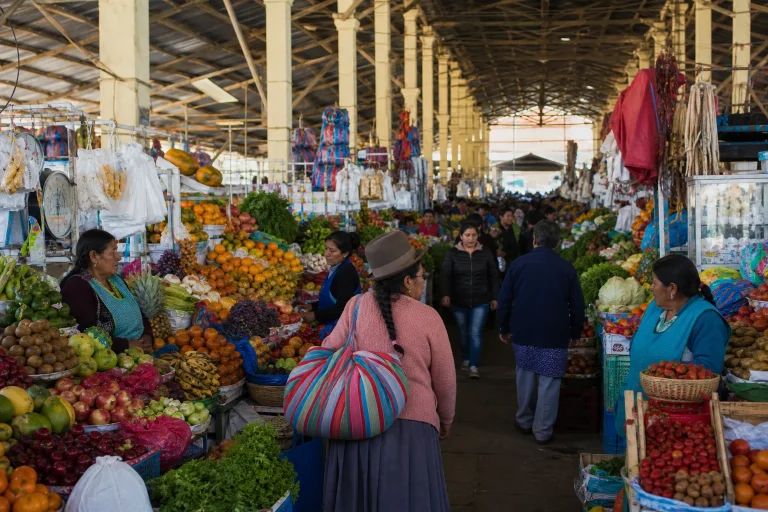 Produce stalls and shoppers inside San Pedro Market in Cusco