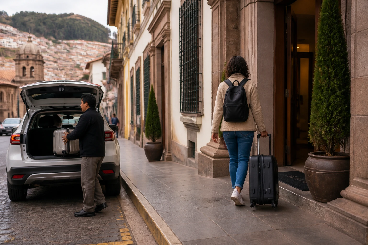 Traveler arriving with luggage at a vehicle-accessible Cusco hotel